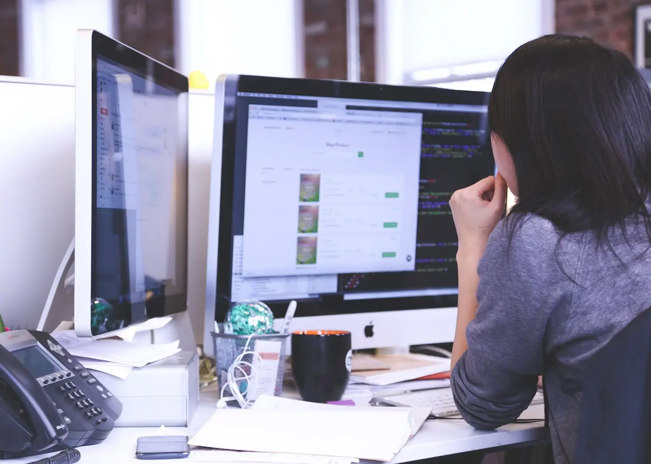 A woman looking at desktop screen